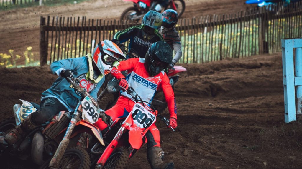 Motocross riders racing on track